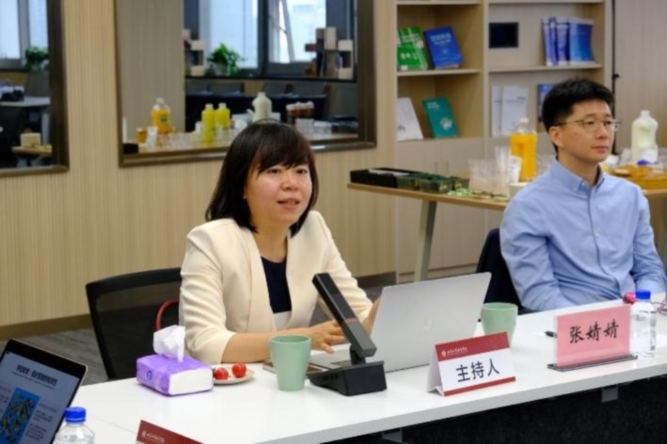 A person sitting at a table with a computer

Description automatically generated